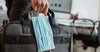Man carrying bag and face mask in hand